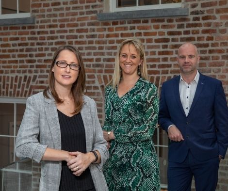 two women and a man standing together